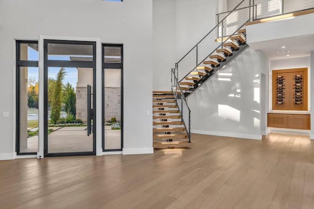 entryway featuring a high ceiling and hardwood / wood-style floors