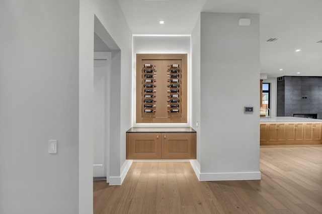 wine room with light hardwood / wood-style flooring