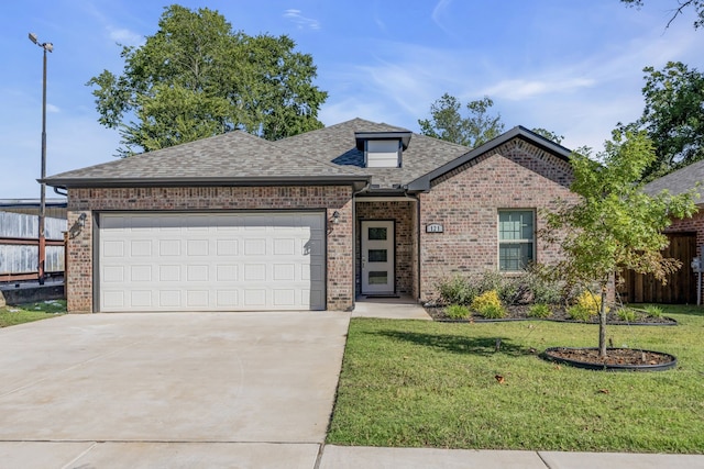 view of front of property with a garage and a front lawn