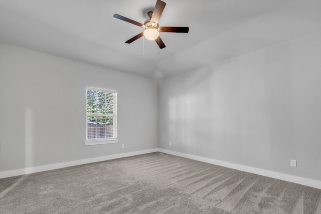 spare room with ceiling fan and carpet