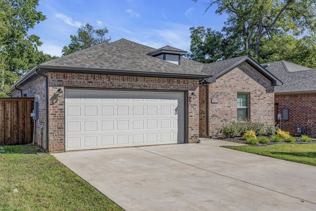 view of front of house featuring a garage and a front lawn