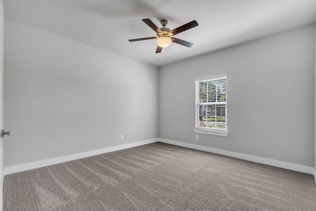 unfurnished room featuring ceiling fan and carpet