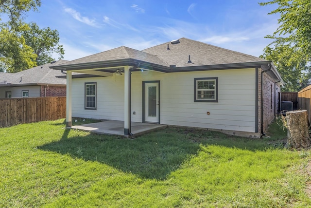 back of house featuring a patio and a yard