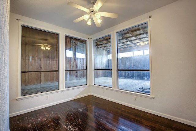 unfurnished room with ceiling fan and hardwood / wood-style flooring