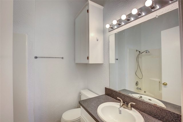 full bathroom featuring shower / washtub combination, vanity, and toilet