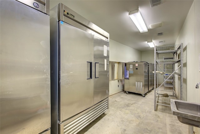 interior space with sink and high end fridge