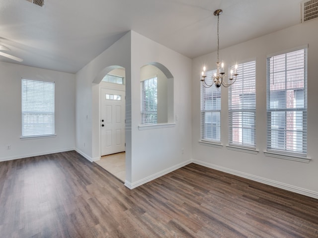 entrance foyer with ceiling fan with notable chandelier and hardwood / wood-style floors