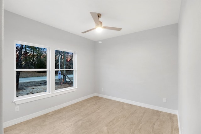 spare room featuring light hardwood / wood-style floors and ceiling fan