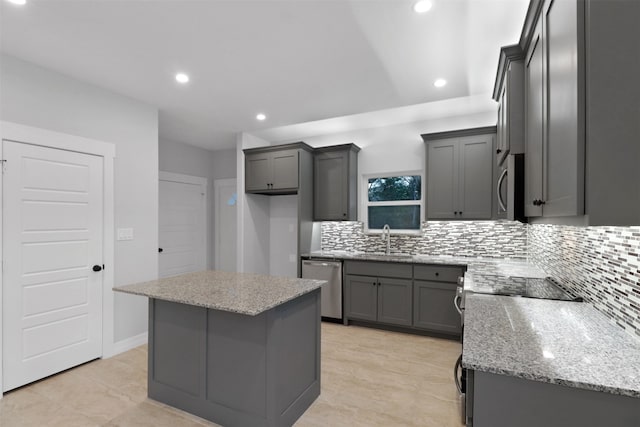 kitchen featuring gray cabinets, a kitchen island, and stainless steel appliances