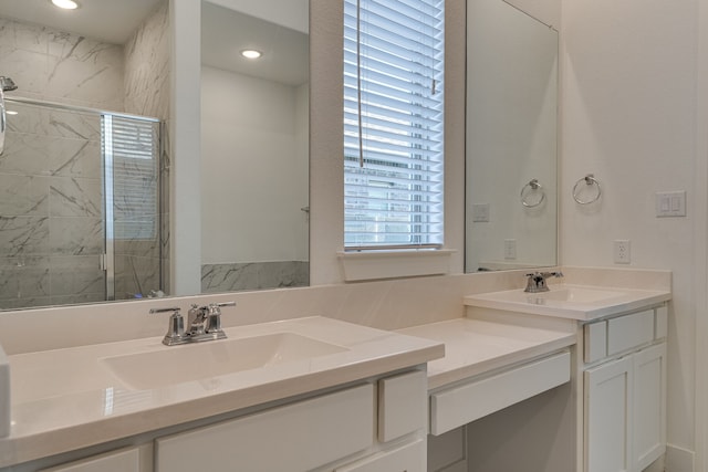 bathroom with vanity and a shower with door