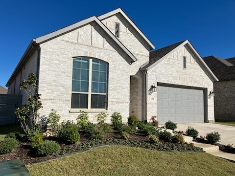 view of front of home with a garage and a front lawn