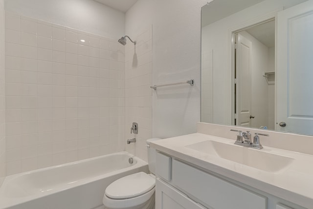 full bathroom featuring toilet, tiled shower / bath combo, and vanity