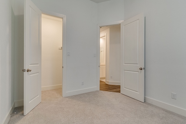 unfurnished bedroom featuring light colored carpet