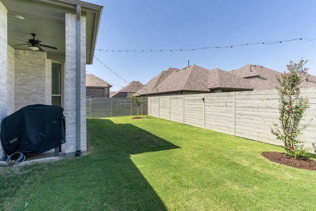 view of yard with ceiling fan