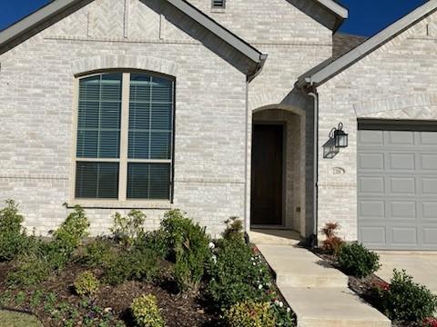 doorway to property featuring a garage