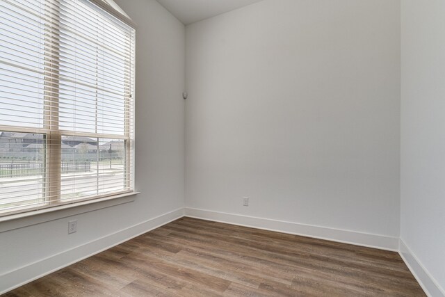 empty room with dark wood-type flooring