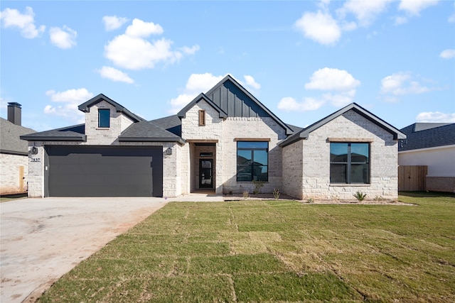 view of front of house with a garage and a front lawn