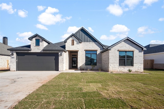 view of front of property with a garage and a front lawn