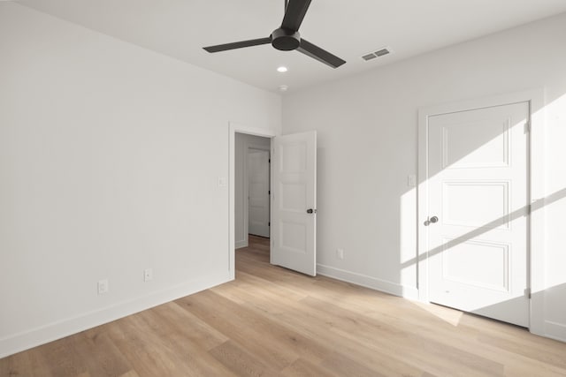 empty room with ceiling fan and light wood-type flooring