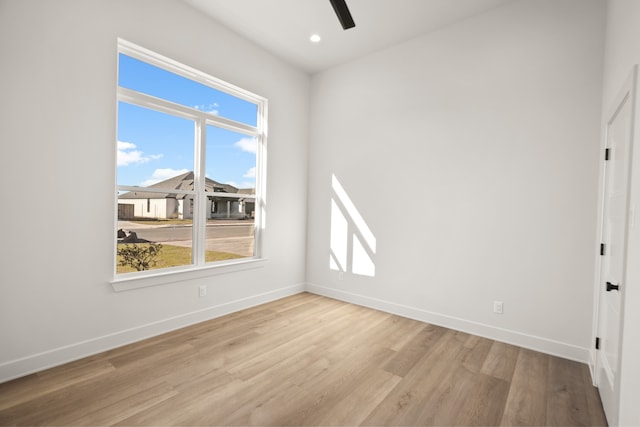 spare room featuring light hardwood / wood-style floors and ceiling fan