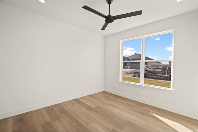 spare room featuring light hardwood / wood-style flooring and ceiling fan