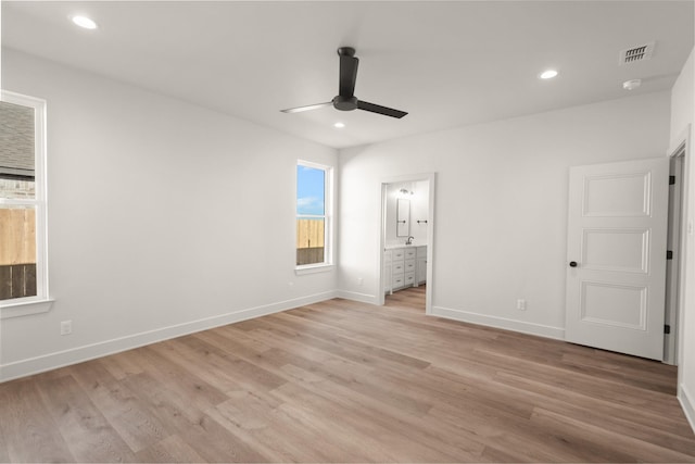 unfurnished bedroom featuring ensuite bathroom, ceiling fan, and light hardwood / wood-style flooring