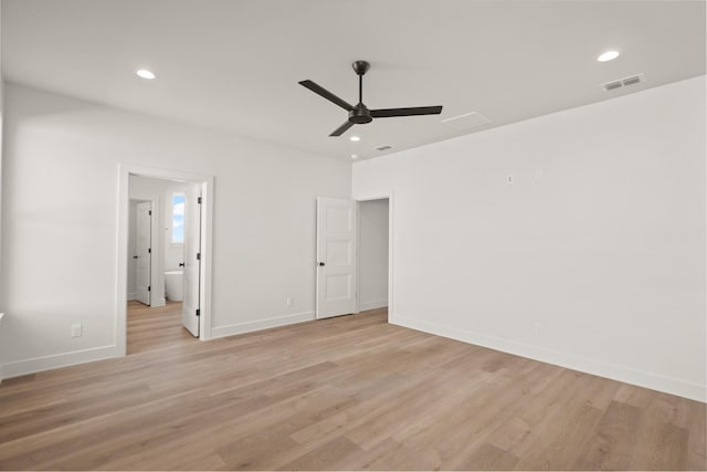 unfurnished bedroom featuring light hardwood / wood-style floors, ceiling fan, and ensuite bathroom