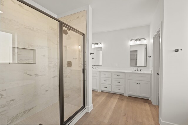 bathroom featuring vanity, hardwood / wood-style flooring, and walk in shower