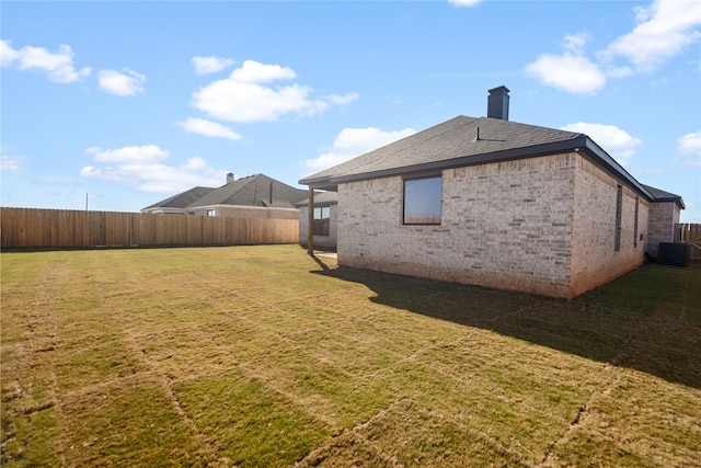 exterior space featuring cooling unit and a yard