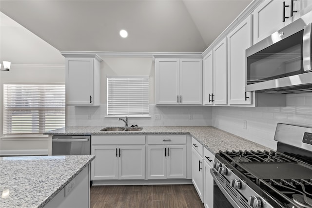 kitchen featuring light stone counters, tasteful backsplash, sink, white cabinetry, and stainless steel appliances