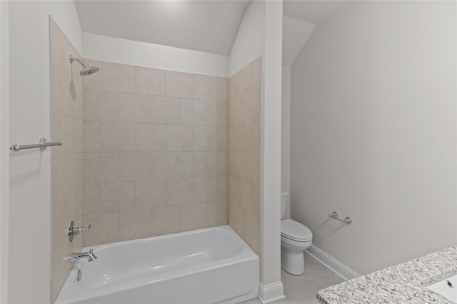 bathroom with tile patterned flooring, vaulted ceiling, tiled shower / bath combo, and toilet