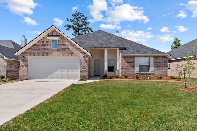 view of front of house featuring a garage and a front lawn