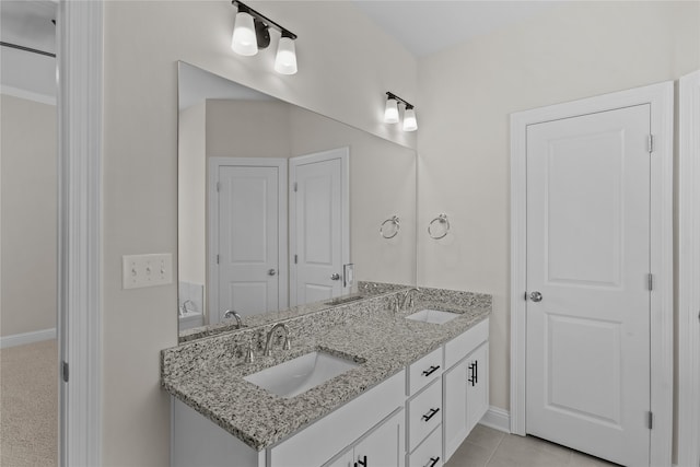 bathroom with tile patterned floors and vanity