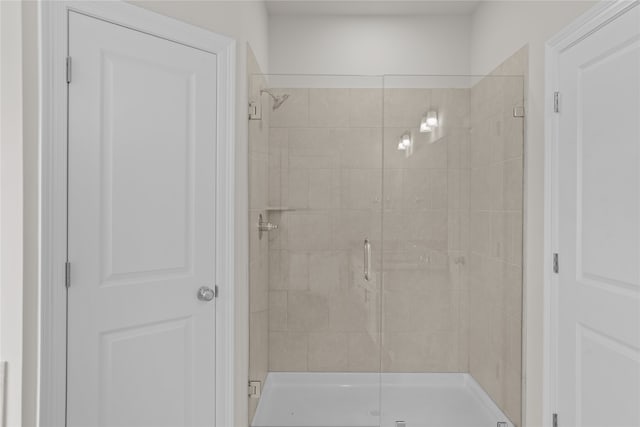 bathroom featuring a shower with shower door