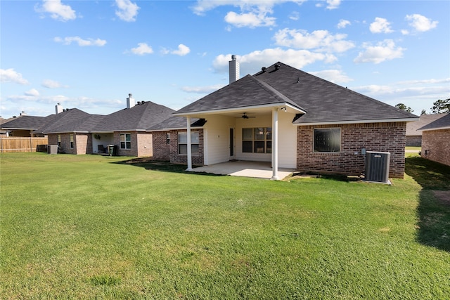 back of property with a yard, a patio area, and central air condition unit