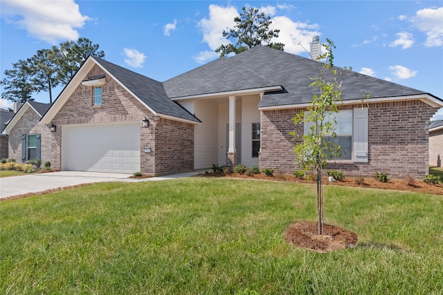 view of front of property with a garage and a front lawn