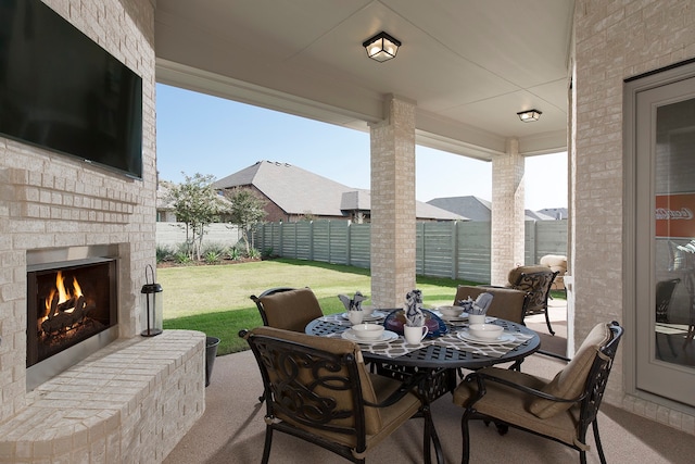 view of patio / terrace featuring an outdoor brick fireplace