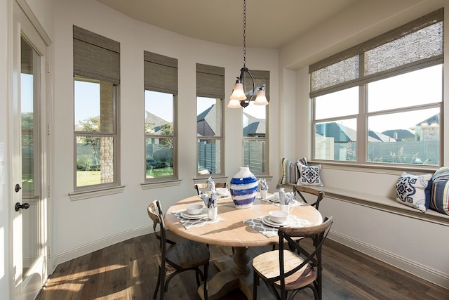 dining space featuring an inviting chandelier and dark hardwood / wood-style flooring