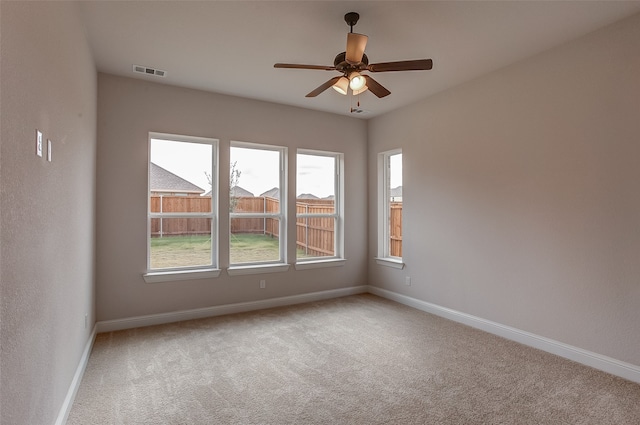 empty room with light carpet and ceiling fan