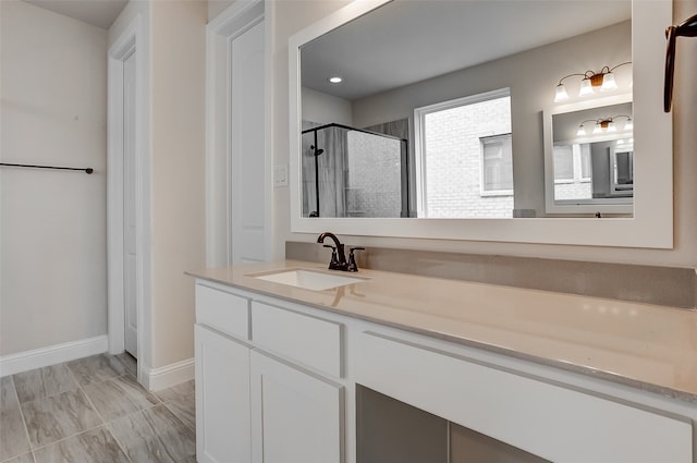 bathroom with walk in shower and vanity