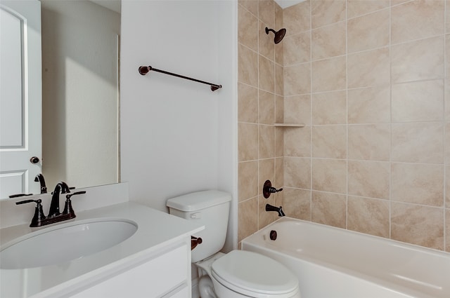 full bathroom with tiled shower / bath, vanity, and toilet