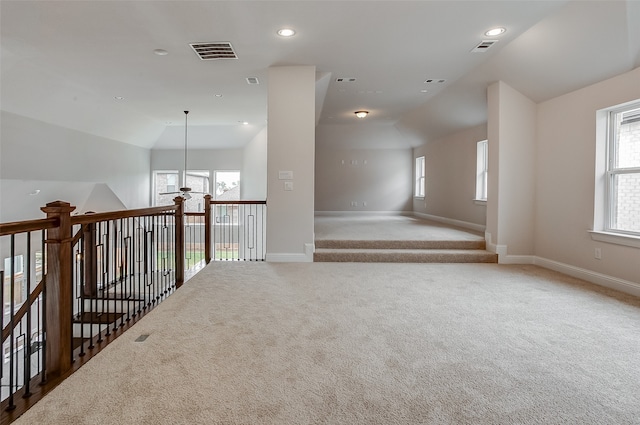 unfurnished room with vaulted ceiling and carpet flooring