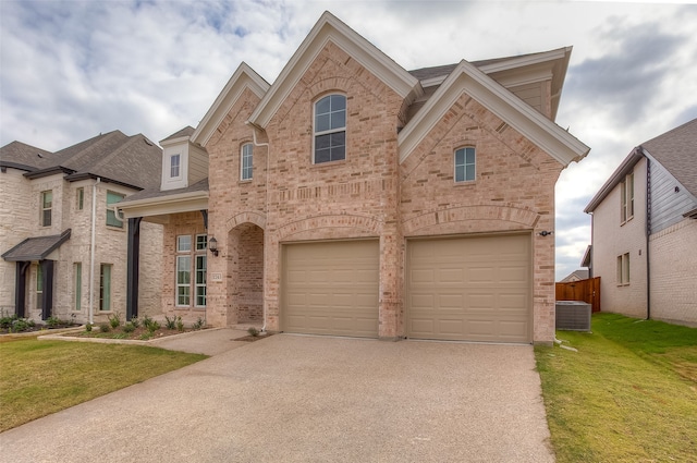 view of front of property featuring a front lawn, central air condition unit, and a garage