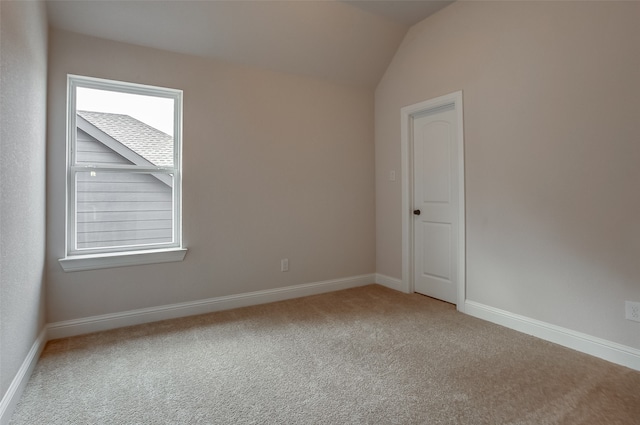 spare room with lofted ceiling and carpet