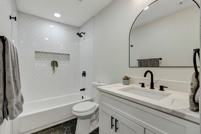 full bathroom with tiled shower / bath, vanity, tile patterned flooring, and toilet