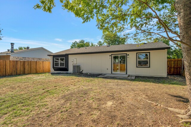 back of house featuring a lawn and central AC unit