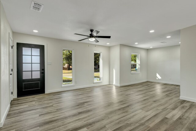 interior space with ceiling fan and light hardwood / wood-style flooring