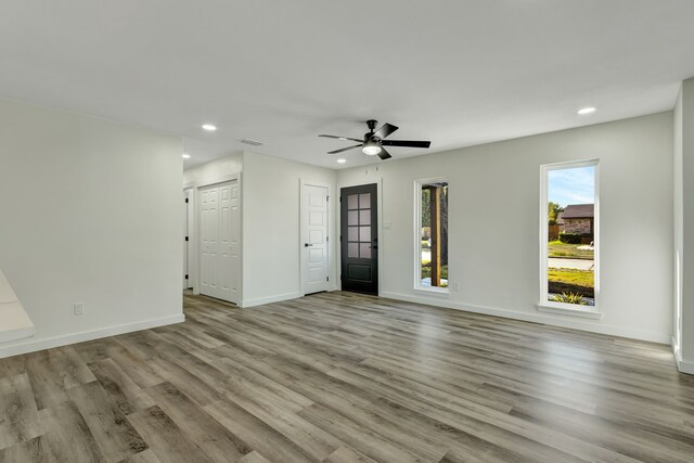 unfurnished room featuring light hardwood / wood-style floors and ceiling fan