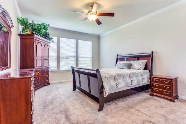 carpeted bedroom featuring ceiling fan and ornamental molding