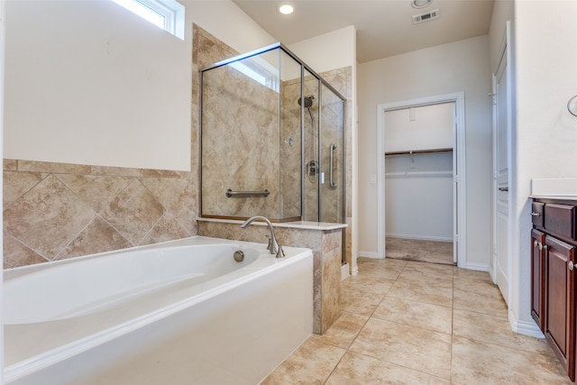 bathroom featuring vanity, tile patterned floors, and separate shower and tub